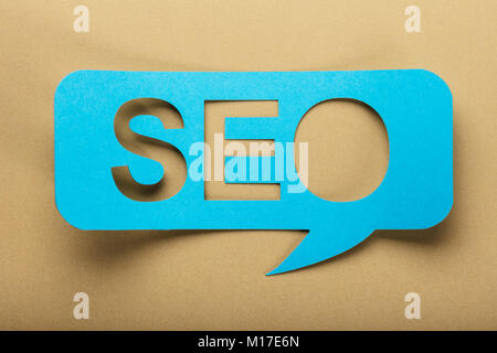 Blue Speech Bubble With Text Seo On Brown Background Stock Photo