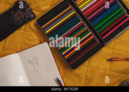 A great collection of wooden crayons on the bed. Stock Photo
