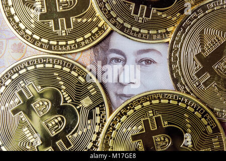 Bitcoin cryptocurrency coins on the ten pound note Stock Photo