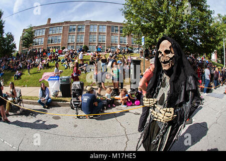 Atlanta, GA, USA - October 21, 2017:  A person dressed as the grim reaper walks by a crowd gathering to watch a Halloween Parade in Atlanta, GA. Stock Photo