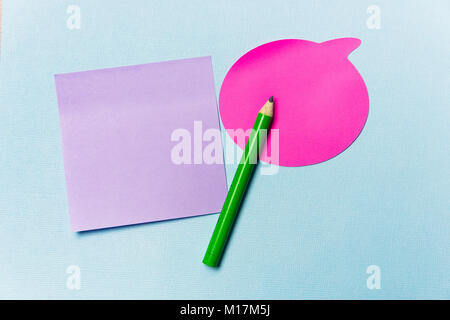 pink and purple stickers, green pencil on a blue background. Stock Photo