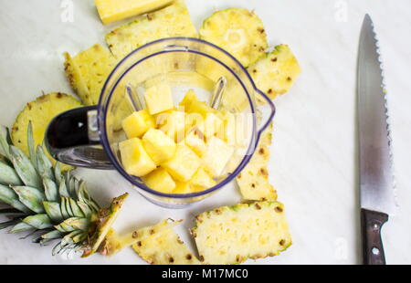 Sliced pineapple in a blender for making smoothie Stock Photo