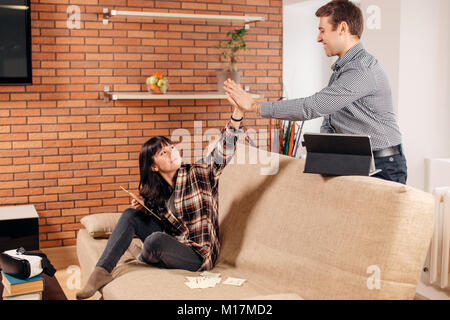 friends giving high five at home while preparing for exams Stock Photo