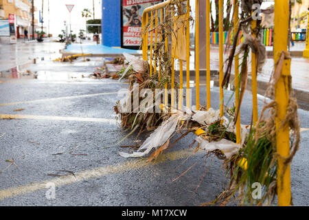 Benidorm, Costa Blanca, Spain, 28th January 2018. The storm last night in Benidorm caused localised flooding. Seen here is the aftermath in La Cala with drain covers lifted and debris washed down the street. A large swathe of the beach sand was also washed away in this small part of Benidorm which floods regularly. Sewage and litter cover the road and beach including sanitary products, wet wipes and paper tissue. Stock Photo