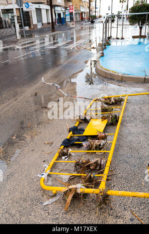 Benidorm, Costa Blanca, Spain, 28th January 2018. The storm last night in Benidorm caused localised flooding. Seen here is the aftermath in La Cala with drain covers lifted and debris washed down the street. A large swathe of the beach sand was also washed away in this small part of Benidorm which floods regularly. Sewage and litter cover the road and beach including sanitary products, wet wipes and paper tissue. Stock Photo