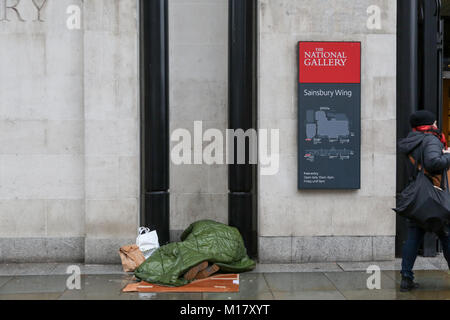 London, UK. 27th Jan, 2018. A homeless person asleep in an alcove at the National Gallery in Trafalgar Square. Stock Photo