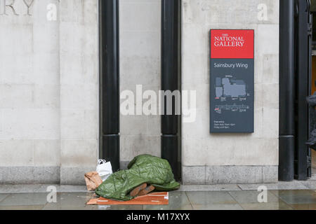 London, UK. 27th Jan, 2018. A homeless person asleep in an alcove at the National Gallery in Trafalgar Square. Stock Photo