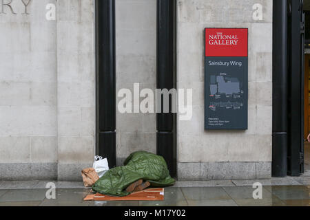 London, UK. 27th Jan, 2018. A homeless person asleep in an alcove at the National Gallery in Trafalgar Square. Stock Photo