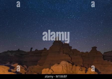 Goblins or hoodoos eroded from Entrada Sandstone, photographed at night with the stars and Milky Way overhead, in Goblin Valley State Park, Utah, USA Stock Photo