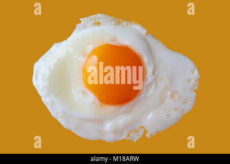 Fried egg on yellow background, close up Stock Photo