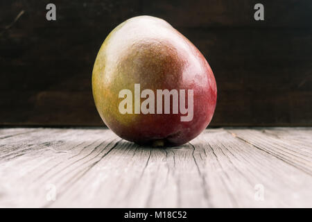 mango on a dark wood background. tinting. Stock Photo