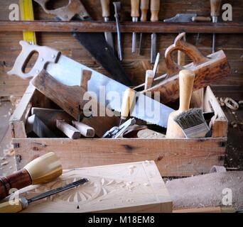 Different tools in wooden box in garage Stock Photo