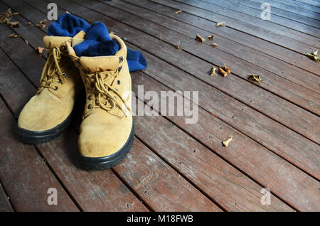 Work boots on a wooden deck Stock Photo