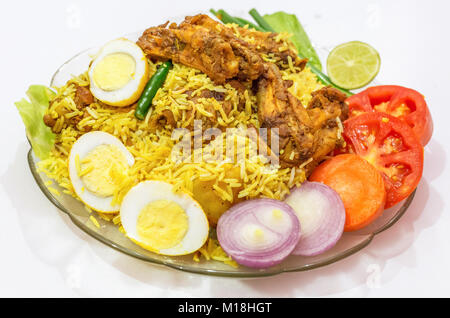 Spicy chicken biriyani rice with sliced eggs and garnished with vegetables. Biriyani is a popular Moghlai dish in India. Stock Photo