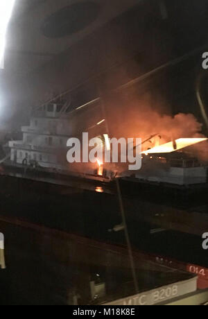 The Coast Guard and local agencies are responding to a vessel fire at mile marker 390 on the lower Mississippi River near Vicksburg, Mississippi, January 25, 2018.  Coast Guard Sector Lower Mississippi River watchstanders received a notification regarding the uninspected towing vessel George King reporting an engine room fire. (U.S. Coast Guard Stock Photo