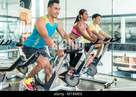 handsome and confident young man during group class of HIIT indo Stock Photo