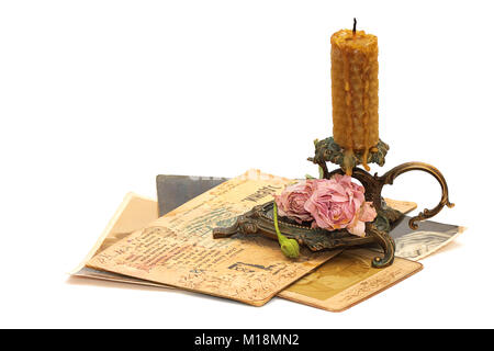 Antique bronze candlestick, roses, old photos and correspondence isolated on white background Stock Photo