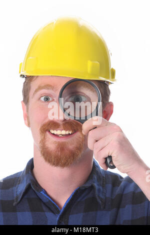 construction worker with loupe on white background Stock Photo