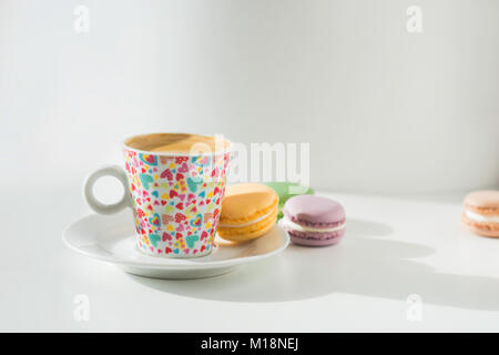 Coffee with macaroons on white table Stock Photo