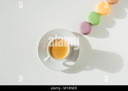 Coffee with macaroons on white table Stock Photo