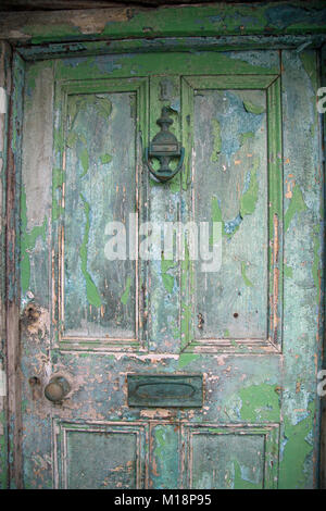 Close up on an old green distressed door Stock Photo