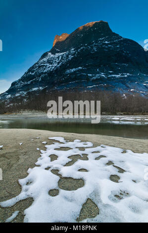 Alpenglow on the mountain Romsdalshorn, 1550 m, in Romsdalen valley, Møre og Romsdal, Norway. Stock Photo