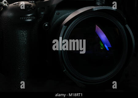 Photography occupation background image concept - professional modern DSLR camera with wide lens in close-up ( low key light) Stock Photo