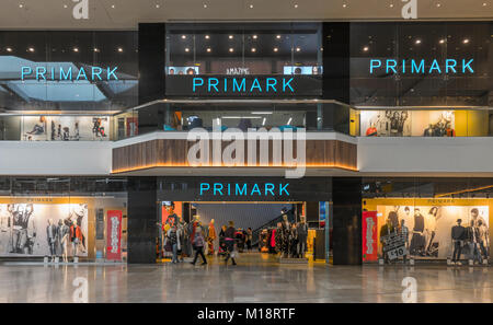 Primark shop / store on two levels of the Queensgate Centre, with customers shopping / browsing, in Peterborough city, Cambridgeshire, England, UK. Stock Photo