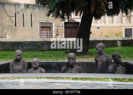 STONE TOWN, ZANZIBAR - JAN 3, 2018: Slavery monument with sculptures and chains near the former slave trade place in Stone town, UNESCO World Heritage Stock Photo