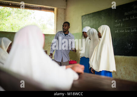 KENDWA, ZANZIBAR - JAN 10, 2018: Teacher with students during English lesson, Primary school at Kendwa, Zanzibar Stock Photo
