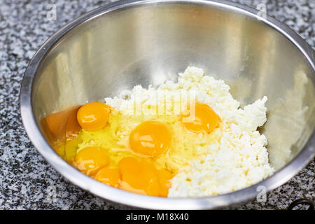 Egg yolks on chopped cheese, close up. Stock Photo