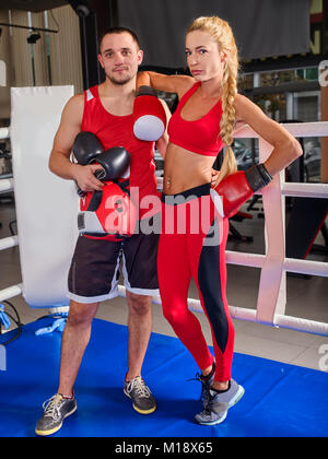 Female boxer with your male coach after workout. Stock Photo