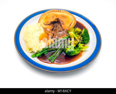 Tasty Yorkshire meal steak and ale pie with mashed potatoes  Broccoli Green beans and gravy Stock Photo