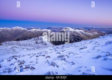 Snow covered peaks of Pillar, Kirk Fell, Lingmell & Great Gable from Scafell Pike in the English Lake District, Cumbria UK Stock Photo