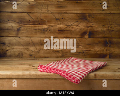 Empty wooden table with red checked tablecloth. Kitchen rustic background Stock Photo