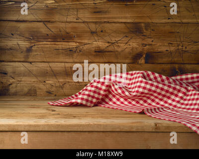 Empty wooden table with red checked tablecloth. Kitchen rustic background Stock Photo