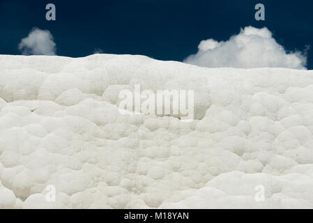 White travertines texture with cloudy sky like cotton at Pamukkale Denizli Turkey. Stock Photo