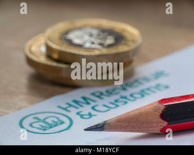 HM Revenue and Customs tax return and self assessment form with some loose change - people having to 'sharpen the pencil' to pay taxes Stock Photo