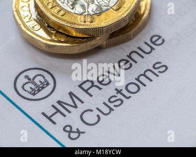 HM Revenue and Customs tax return and self assessment form with some loose change - people having to 'sharpen the pencil' to pay taxes Stock Photo