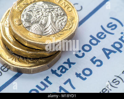 HM Revenue and Customs tax return and self assessment form with some loose change - people having to 'sharpen the pencil' to pay taxes Stock Photo