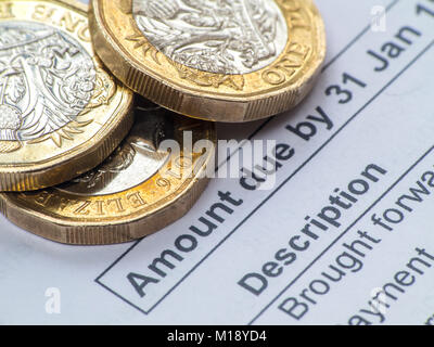 HM Revenue and Customs tax return and self assessment form with some loose change - people having to 'sharpen the pencil' to pay taxes Stock Photo