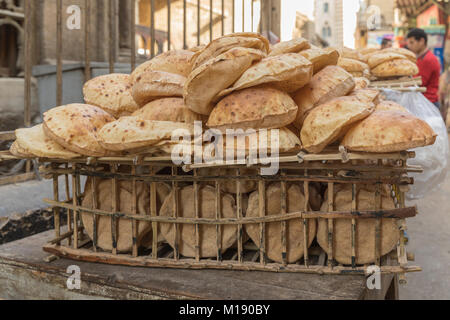 Whole grain Egyptian eish baladi pita bread on sale in a Cairo street market Stock Photo