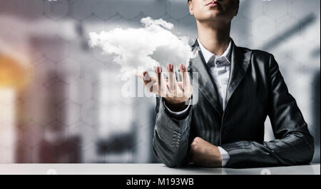 Woman presenting cloud in her hand. Stock Photo