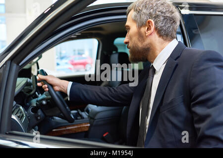 Mature Man Choosing Car for Rent Stock Photo