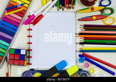 colorful school office supplies with notepad in middle Stock Photo