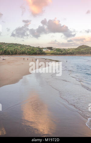 Gonubie beach river mouth at sunset. Late day fun at the seaside. Holiday background Stock Photo