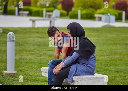 Isfahan, Iran - April 24, 2017: Young iranian couple on date in city park. Stock Photo