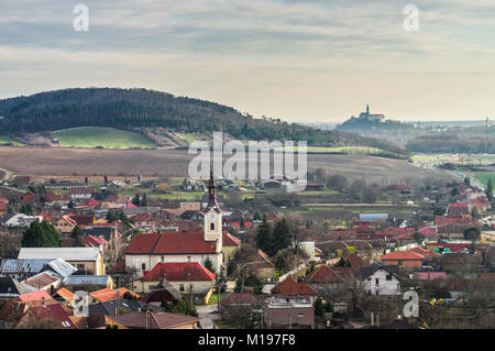 Scenic Drazovce village with the city and castle of Nitra on the hillside in the background - Slovakia Stock Photo