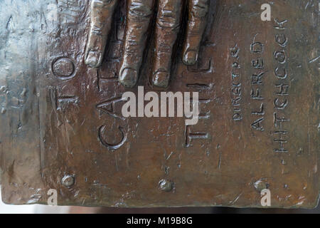 Bronze statue of movie star Cary Grant, holding a copy of To Catch a Thief. Millenium Square. Bristol, UK. Stock Photo