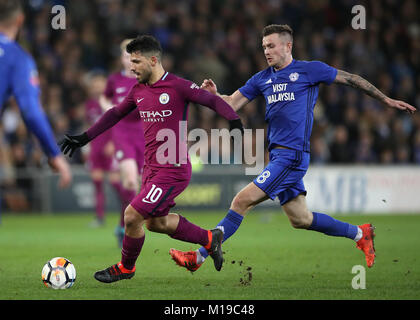 Manchester City's Sergio Aguero (left) and Cardiff City's Joe Ralls in action during the Emirates FA Cup, Fourth Round match at Cardiff City Stadium. Stock Photo